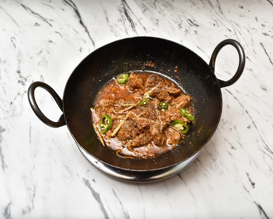 Lamb karahi with ginger and green chilli, served in the black karahi pan